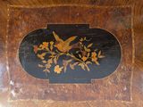 a picture of a wooden table with a bird and flowers on it