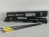 a pair of arrows and a box of arrows on a table