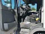 a white truck with the door open and the driver ' s seat down