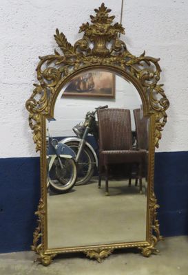 a mirror that is sitting on the floor next to a chair