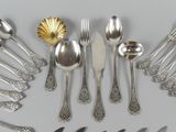 a lot of silver spoons and forks arranged in a circle
