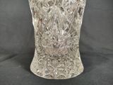 a glass vase that is sitting on a black surface