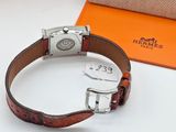 a brown leather bracelet with a silver buckle on it