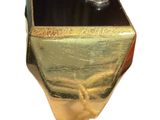 a gold and black ring with a diamond on it