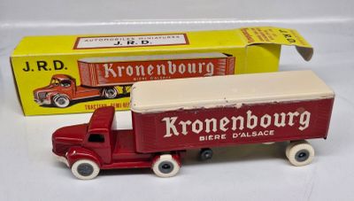 a toy truck that is sitting next to a box of kronenhburg beer