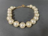 a close up of a white pearl necklace on a table