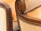 a couch and chair in a living room with wood trimming