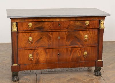 an antique chest of drawers with marble top and brass handles
