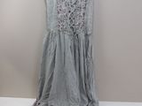 the dress is hanging on a hanger on the wall