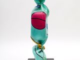 a close up of a sculpture of a candy on a black stand