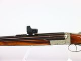 a rifle with a gun on a white background