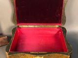 a gold and red box sitting on a table