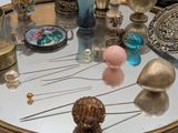 a table with a mirror and a bunch of objects on it