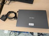 a laptop that is sitting on a desk with a keyboard and mouse