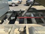 a truck that is parked in a lot with its hood open