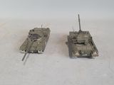 two toy tanks sitting next to each other on a table