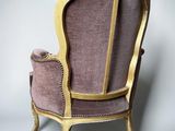 an image of a pink and gold chair against a white wall