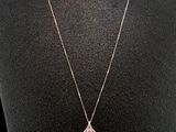 a close up of a necklace on a mannequin mannequin