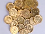 a pile of gold coins on a white surface