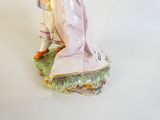 a figurine of a woman in a pink dress