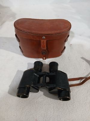 an old pair of binoculars sitting on top of a white blanket