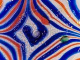 a close up of a colorful glass object on a table