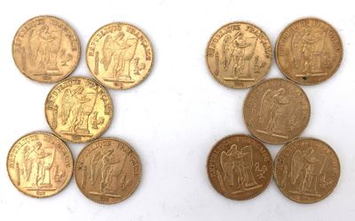 six different types of gold coins are shown on a white surface