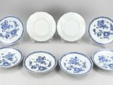 a set of six blue and white plates with floral designs