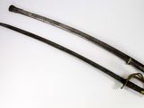 pair of antique japanese swords on a white surface with a white background