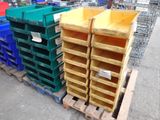 many different colored bins stacked on pallets in a warehouse