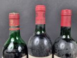 three bottles of wine are lined up on a table