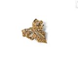 a close up of a gold pin with a cross on it