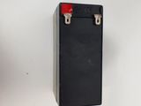 a close up of a black battery box on a white surface