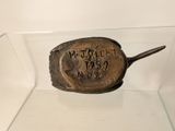 a metal object with writing on it in a glass case