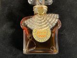a close up of a bottle of perfume on a black surface