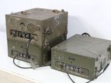 two army green boxes sitting next to each other on a white surface