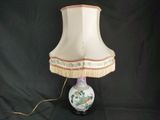 a lamp that is sitting on a table with a lamp shade on it