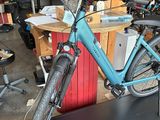 a blue bicycle that is on display in a shop
