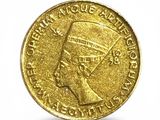 a close up of a gold coin on a white background