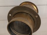 a close up view of a brass object on a white surface