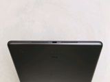 the back of a black laptop computer sitting on top of a white table