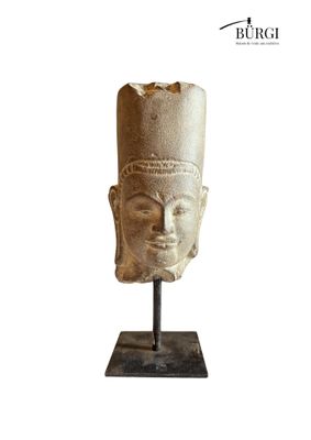an image of a stone head on a stand with a white background