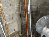 a pile of skis and poles in the corner of a room
