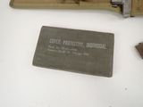 a small piece of paper on the table next to a small piece of metal