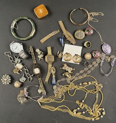an assortment of jewelry including a watch, bracelets, rings, and other items
