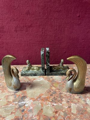 a pair of bookends that are on a marble table