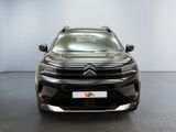 the front of a black citrole parked in a white room