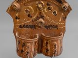 an image of a brown vase with two cups on it