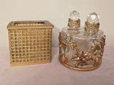 a gold box and a glass perfume bottle sitting on a table