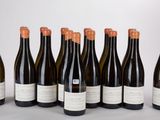 six bottles of wine are lined up in a row on a table